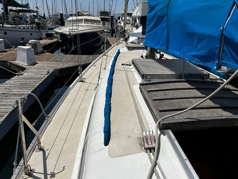1978 Ericson 35 Sloop docked at a marina with blue sail cover.