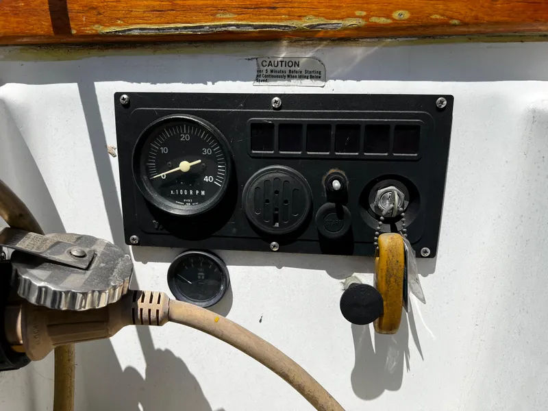 Control panel of a 1978 Ericson 35 Sloop sailboat with gauges and switches.