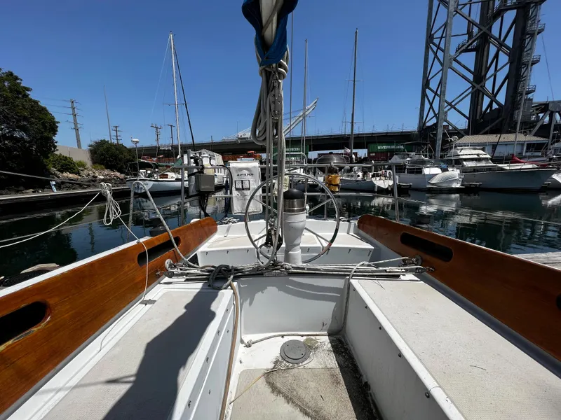1978 Ericson 35 Sloop sailboat docked in a marina, clear blue sky.