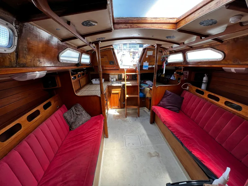 Interior of a 1978 Ericson 35 Sloop sailboat with red cushioned seating.