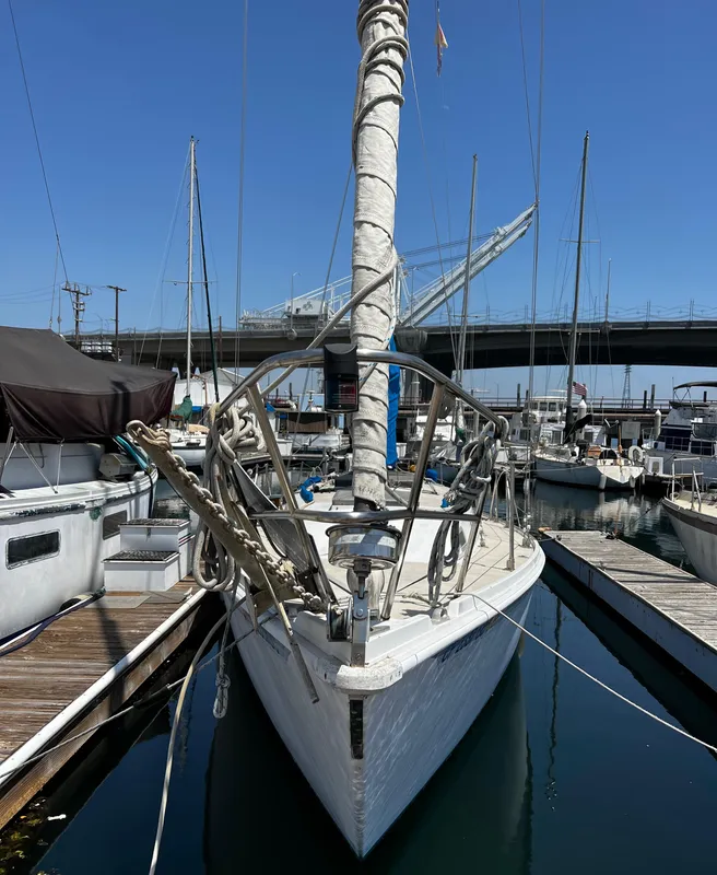 1978 Ericson 35 Sloop docked at a marina under a clear blue sky.