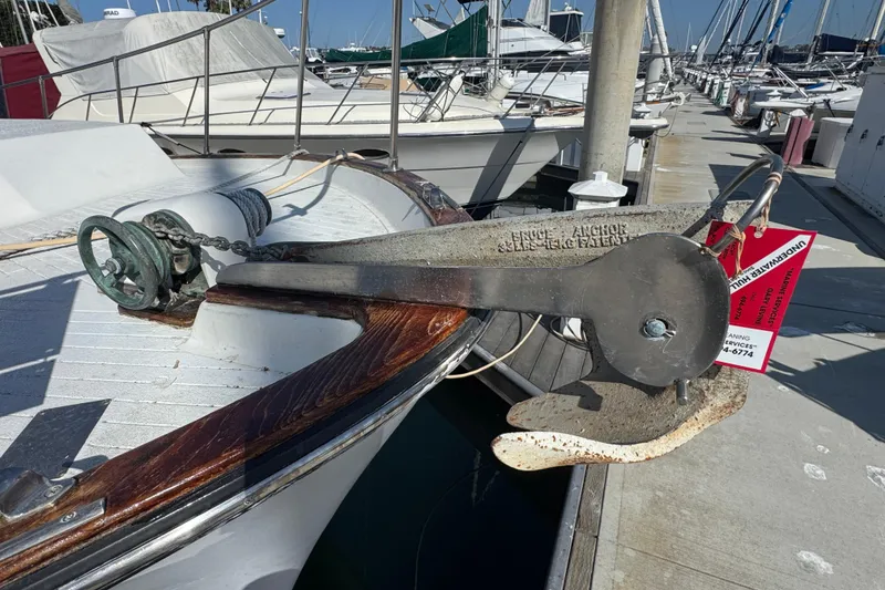 1977 Tollycraft 37 Convertible boat with anchor on deck at marina.