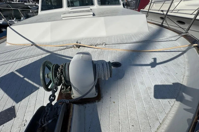 1977 Tollycraft 37 Convertible boat deck with anchor winch and rope.