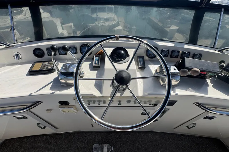 1977 Tollycraft 37 Convertible helm with steering wheel and control panel.