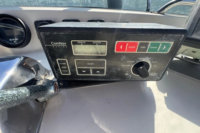 Control panel of a 1977 Tollycraft 37 Convertible boat with ComNav Marine system.