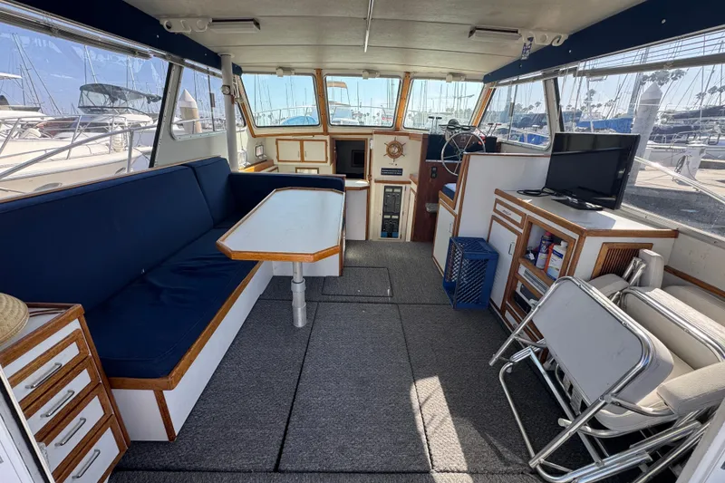 Interior of a 1977 Tollycraft 37 Convertible yacht with seating and navigation area.