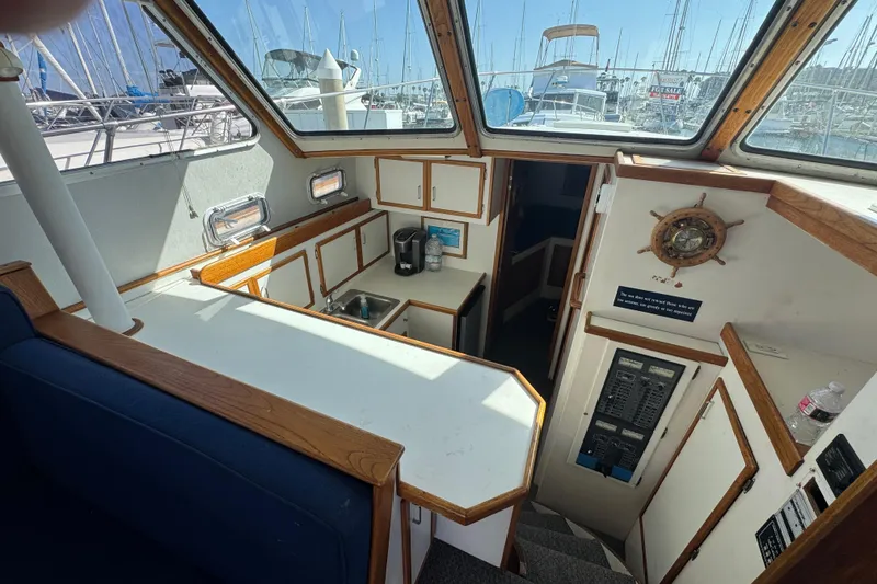1977 Tollycraft 37 Convertible yacht interior with kitchenette and nautical decor.