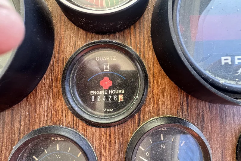 Close-up of Tollycraft 37 Convertible 1977 engine hour meter showing 2426 hours.