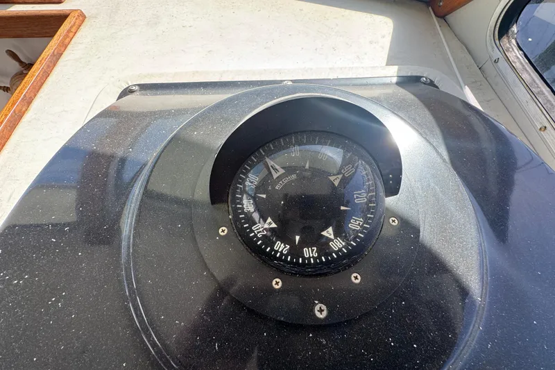 Compass on 1977 Tollycraft 37 Convertible boat dashboard, showing navigation details.