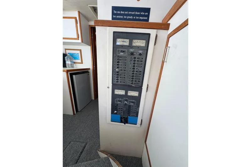 Electrical panel inside a 1977 Tollycraft 37 Convertible boat, featuring gauges and switches.