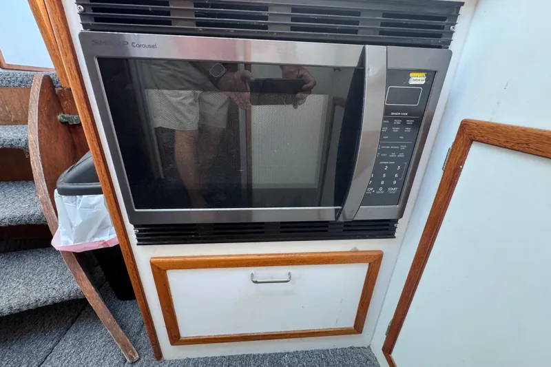 Sharp Carousel microwave in a 1977 Tollycraft 37 Convertible boat interior.