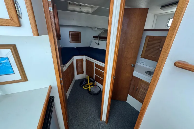 1977 Tollycraft 37 Convertible cabin interior with wood accents and compact layout.