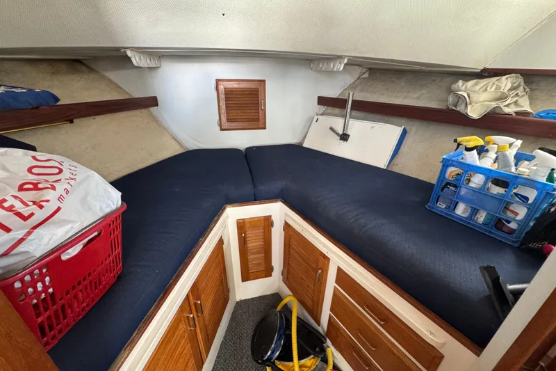 1977 Tollycraft 37 Convertible cabin interior with storage and cleaning supplies.
