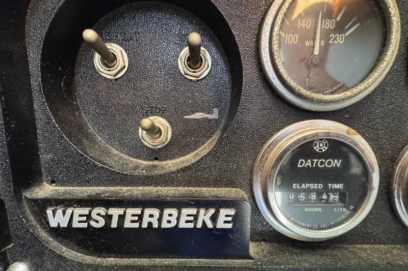 Control panel of a 1977 Tollycraft 37 Convertible with Westerbeke and Datcon gauges.