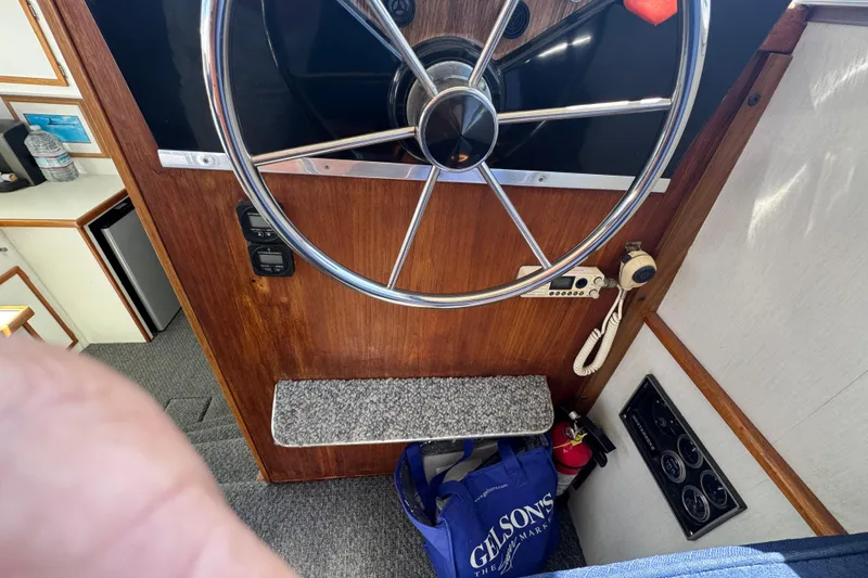 Interior helm of 1977 Tollycraft 37 Convertible with steering wheel and controls.