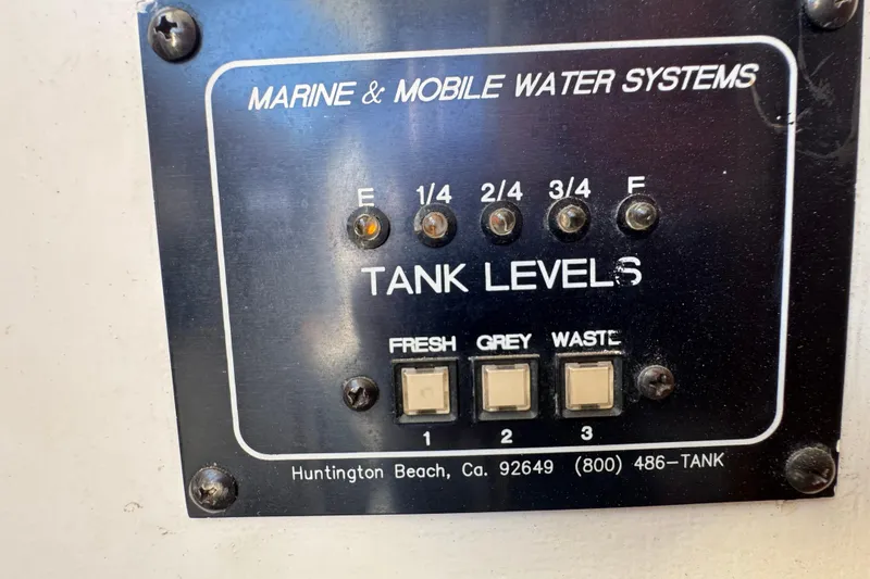 Control panel for marine water systems on a 1977 Tollycraft 37 Convertible boat.