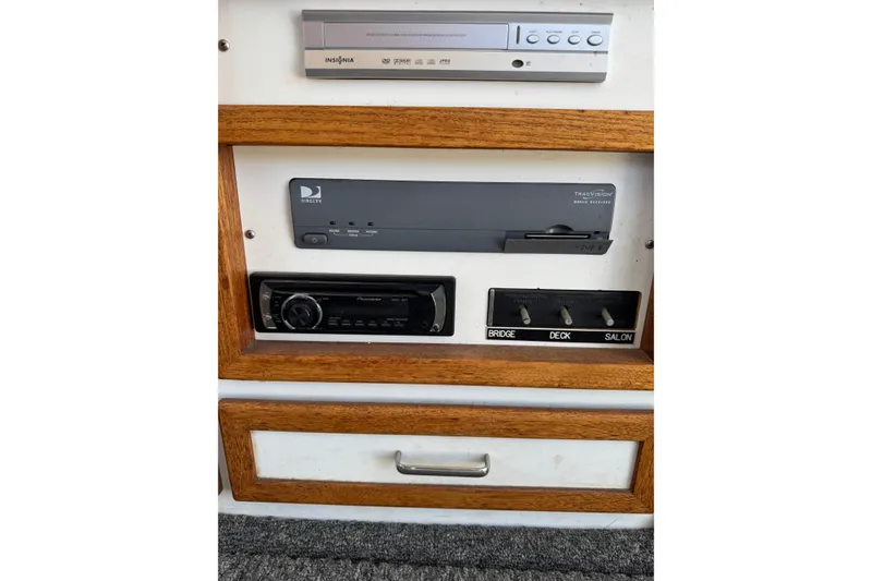 1977 Tollycraft 37 Convertible entertainment system with DVD player and audio controls.