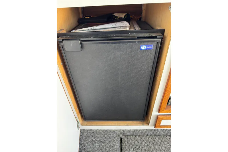 1977 Tollycraft 37 Convertible yacht interior with compact Vitrifrigo refrigerator.