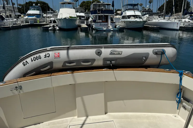 1977 Tollycraft 37 Convertible with inflatable dinghy docked at a marina.