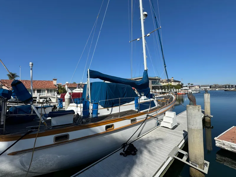 1984 Transpacific Marine Ketch docked at marina under clear blue sky.