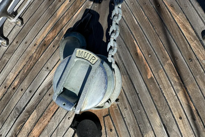 Anchor winch on 1984 Transpacific Marine Ketch's wooden deck.