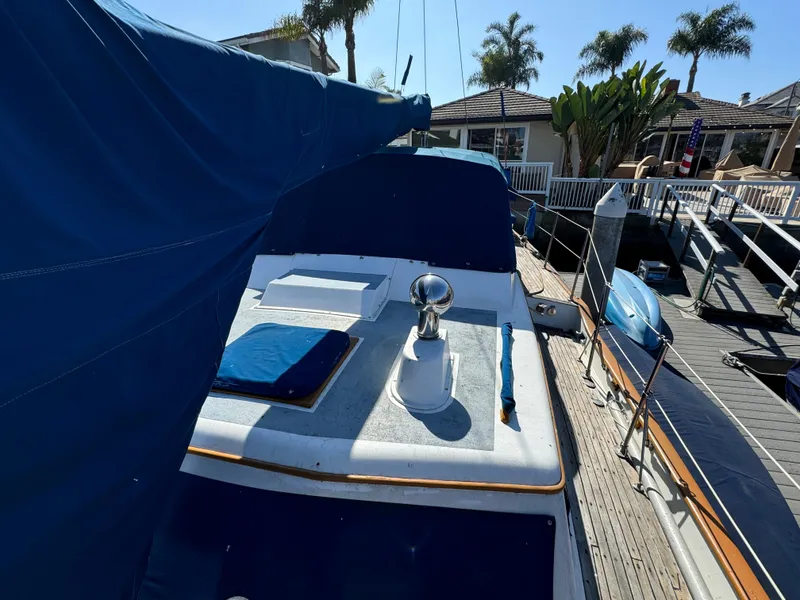 1984 Transpacific Marine Ketch docked, featuring blue covers and deck details.