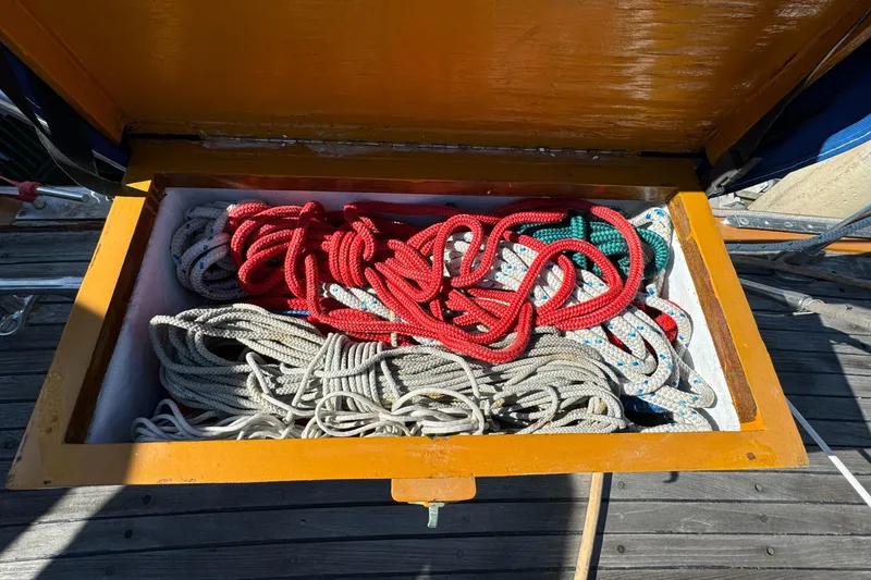 Colorful ropes stored in a wooden compartment on a 1984 Transpacific Marine Ketch.