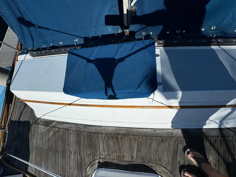 1984 Transpacific Marine Ketch deck with blue canvas and wooden flooring.