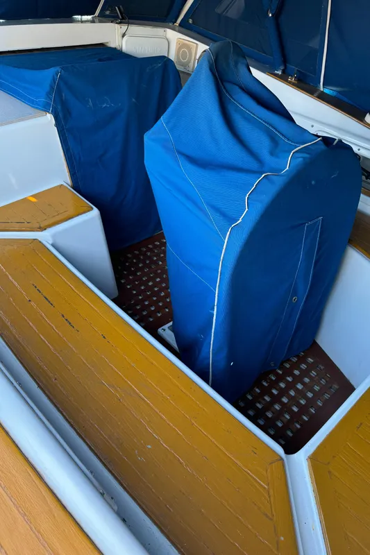 1984 Transpacific Marine Ketch interior with blue covers and wooden flooring.
