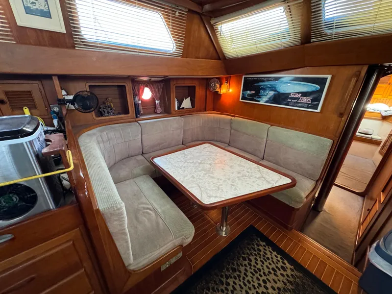 Interior of a 1984 Transpacific Marine Ketch with cozy seating area.