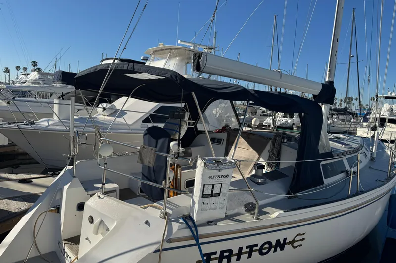 Catalina 42 sailboat from 1989 docked at a marina under clear blue skies.
