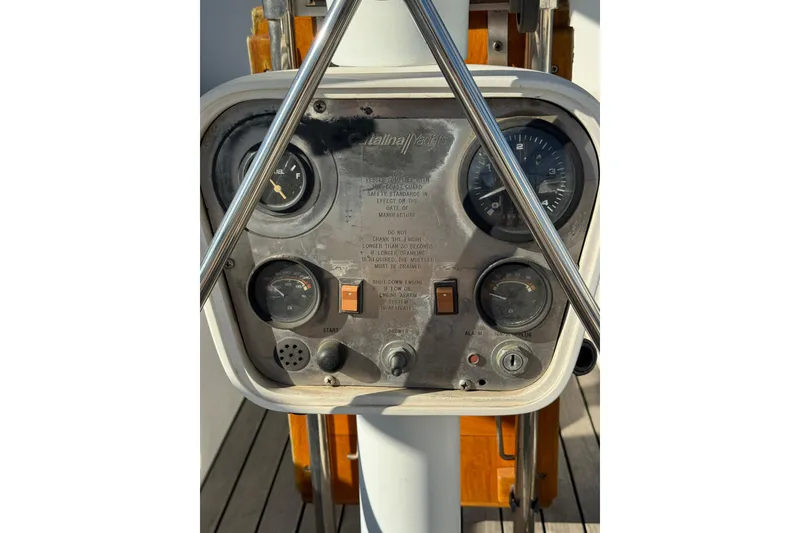 Control panel of a 1989 Catalina 42 yacht with gauges and switches.