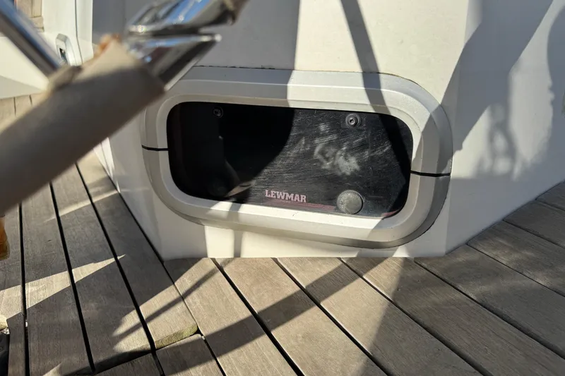 Lewmar hatch on 1989 Catalina 42 sailboat deck, sunlight casting shadows.