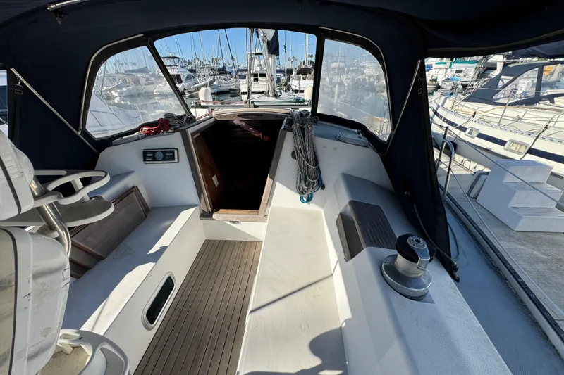 Cockpit view of a 1989 Catalina 42 sailboat docked at a marina.