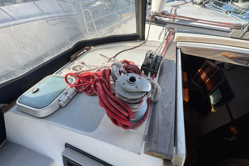 Cockpit of 1989 Catalina 42 sailboat with winch and red ropes.