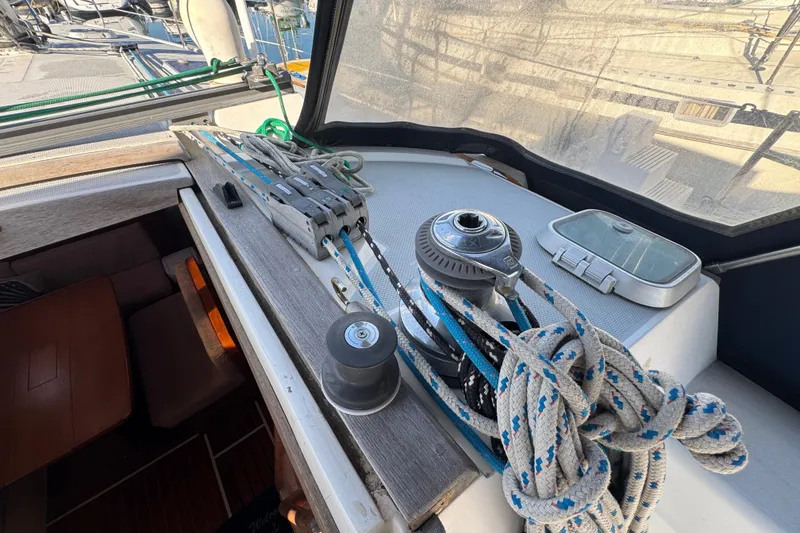 Sailing equipment on a 1989 Catalina 42 yacht, featuring ropes and winch in the cockpit.