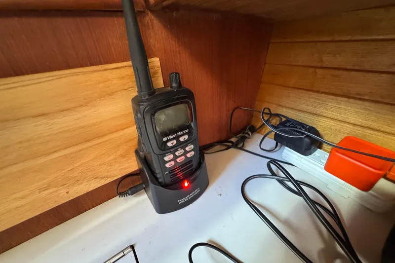 Handheld marine radio charging on a Catalina 42 sailboat, 1989 model.