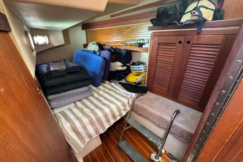 Cozy cabin interior of 1989 Catalina 42 sailboat with storage and bedding.