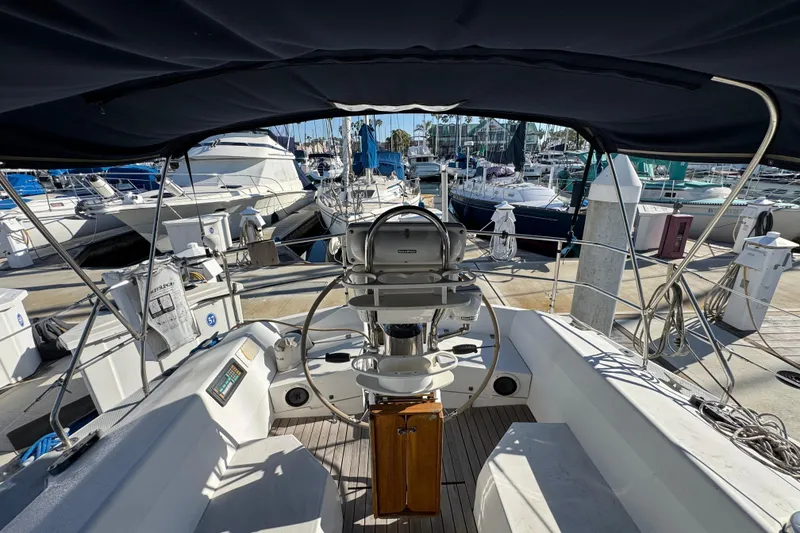 Cockpit view of a 1989 Catalina 42 sailboat docked at a marina.