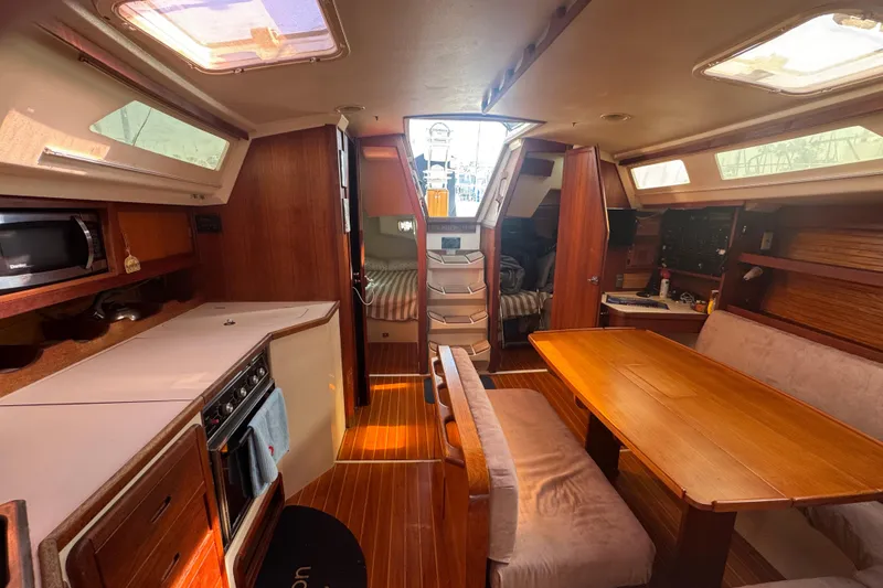 Interior of a 1989 Catalina 42 sailboat with dining area and kitchen.