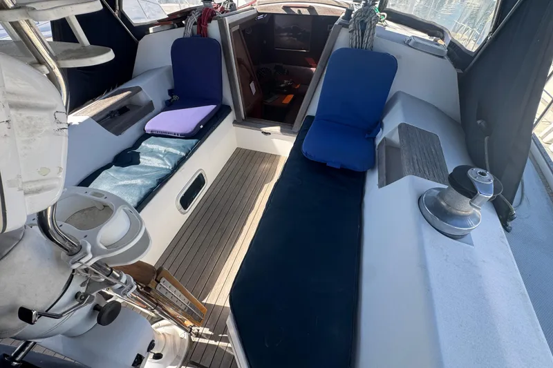 Cockpit of 1989 Catalina 42 sailboat with cushioned seating and winch.