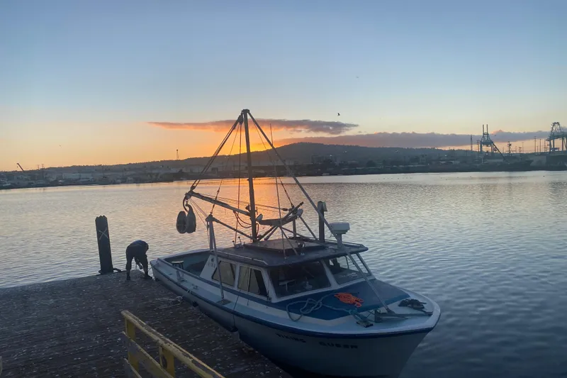 Boat docked at sunset, Roberts 30 model, 1977, serene waterfront view.