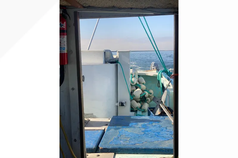 Interior view of a 1977 Roberts 30 boat with ocean in the background.