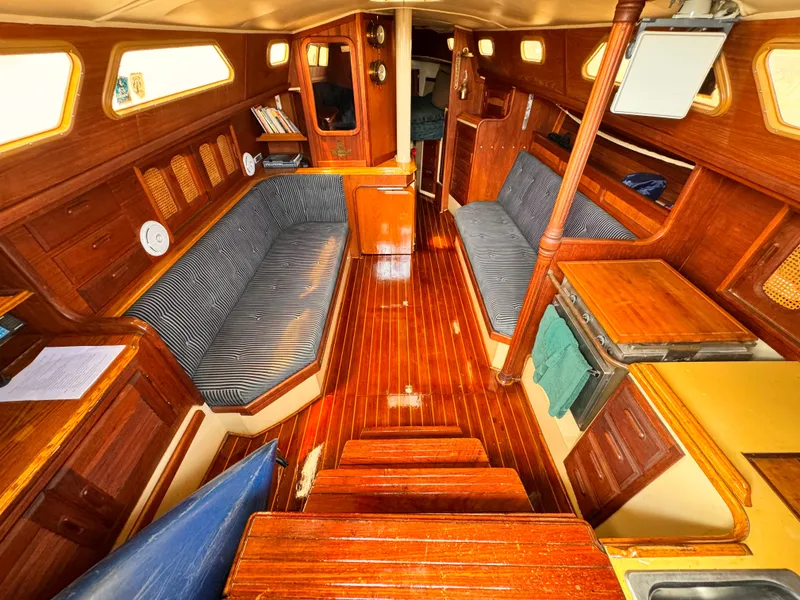 1978 Islander 36 yacht interior with wooden finish and striped seating.
