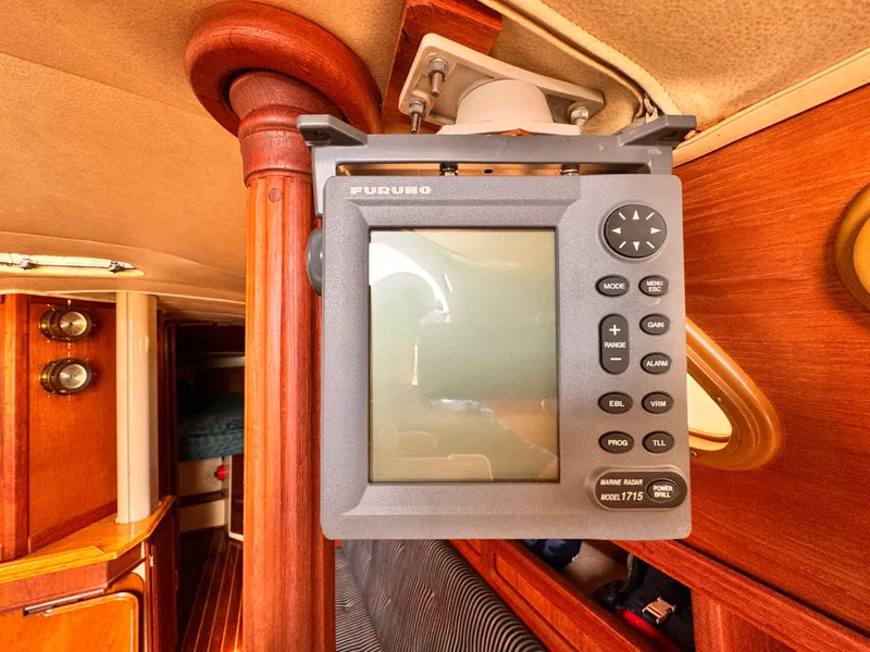 Marine radar system inside a 1978 Islander 36 yacht cabin, featuring wood paneling.