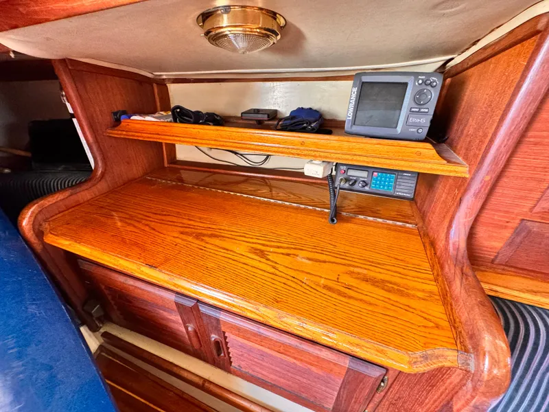 1978 Islander 36 yacht interior with wooden navigation station and electronic equipment.