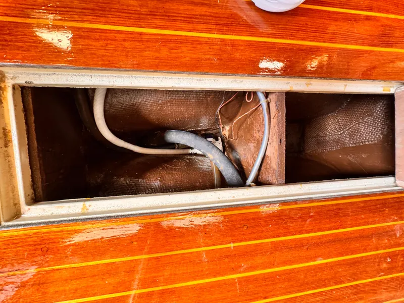 Interior view of 1978 Islander 36 sailboat showing wooden compartment and wiring.