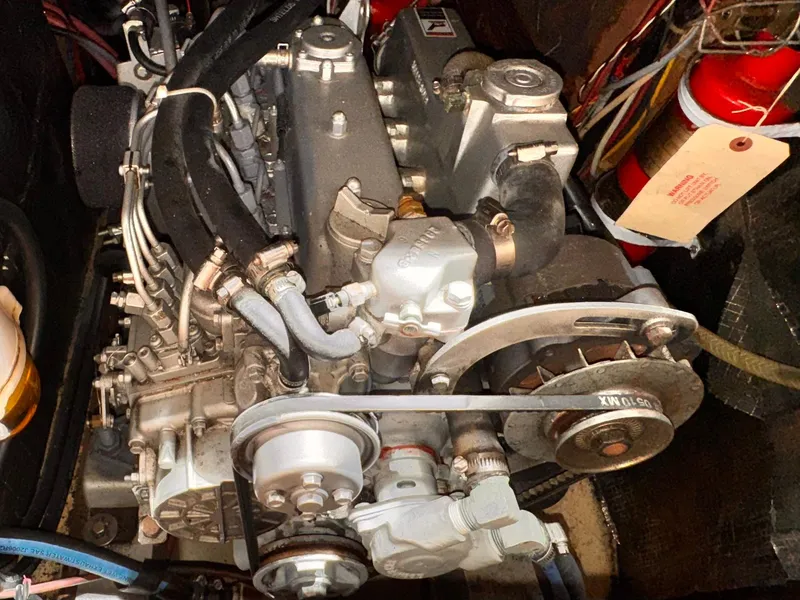 Engine of a 1978 Islander 36 sailboat, showcasing mechanical components and wiring.