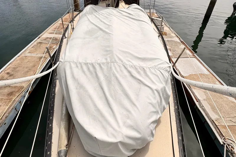 1978 Islander 36 sailboat with covered deck, docked at marina.