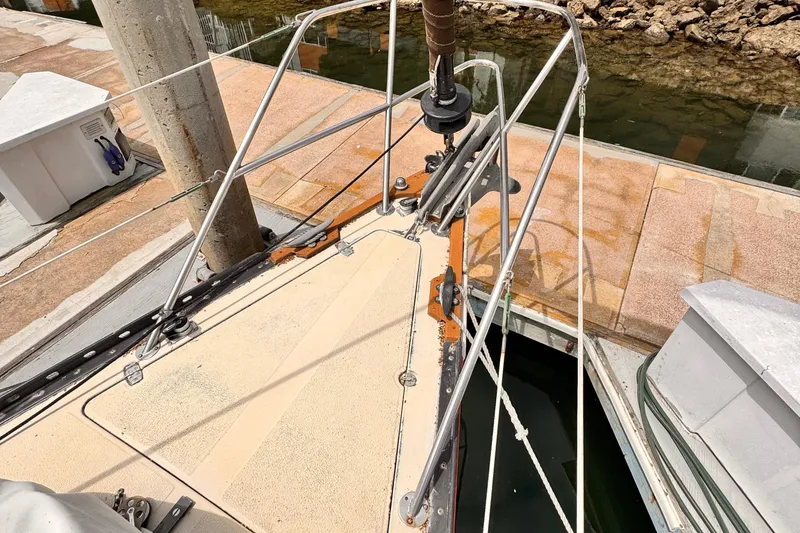 1978 Islander 36 sailboat bow at dock, showing deck and rigging details.